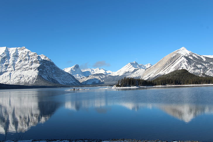 snow covered mountains near body of water during daytime, upper kananaskis lake, canada, upper kananaskis lake, canada