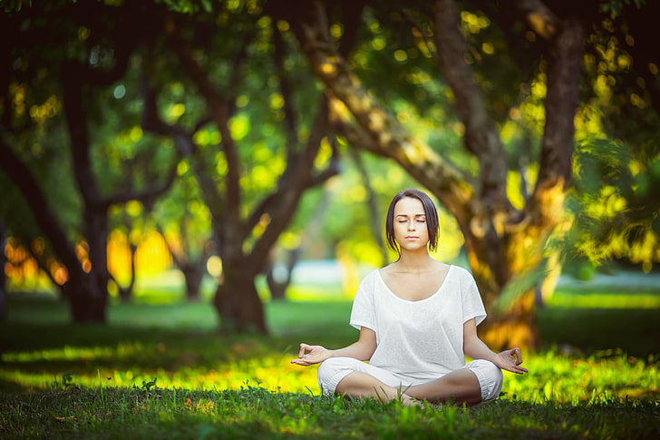 trees, meditation, legs crossed, women outdoors, sunlight, white shirt