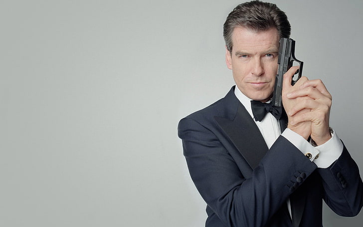 Senior Man Holding Gun In James Bond Pose Stares Challengingly Stock Photo  - Download Image Now - iStock