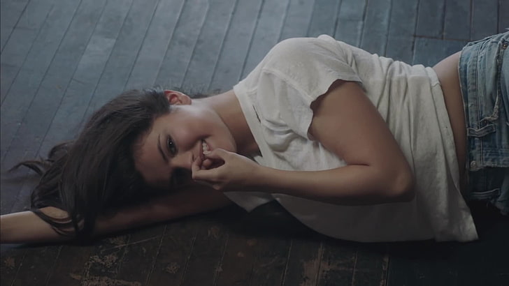 Selena Gomez, finger on lips, lying down, one person, young adult