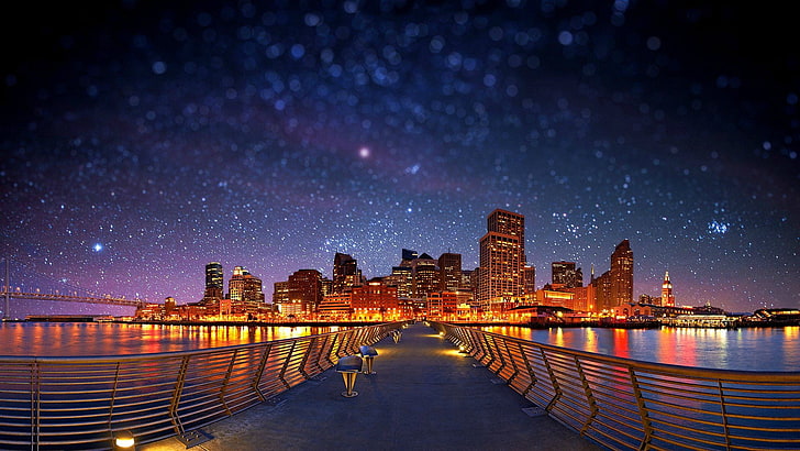 bridge and city buildings, panoramic photography of bridge heading to lighted high-rise buildings during nighttime