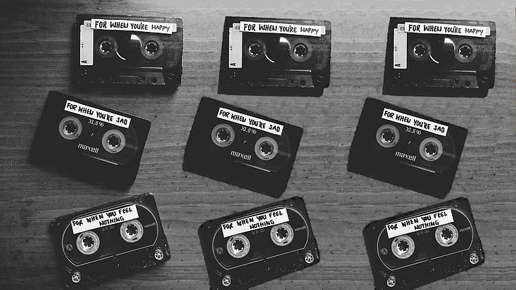 nine black cassette tapes, monochrome, technology, indoors, no people