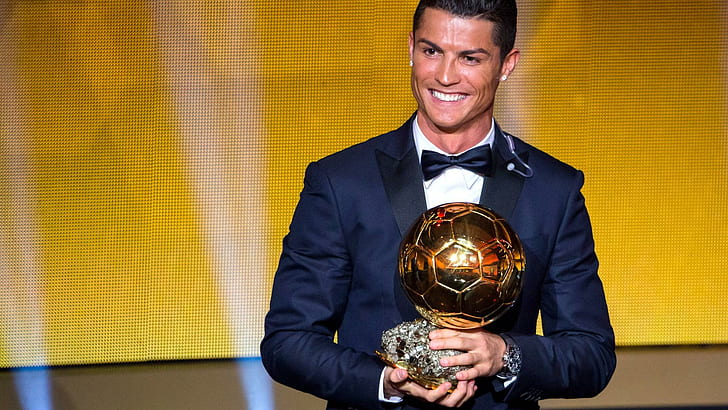 Cristiano Ronaldo of Portugal and Real Madrid receives the 2014 FIFA Ballon d'Or award, men's blue tuxedo