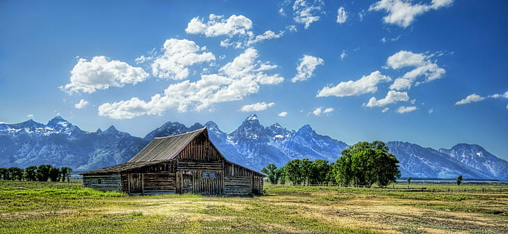 brown wooden house on middle of green grasses photo during daytime, wyoming, wyoming