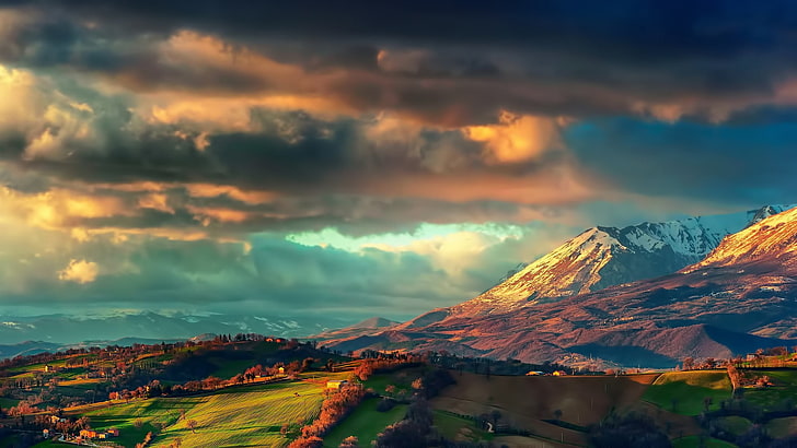 landscape photography of mountains and green field under cloudy sky illustration