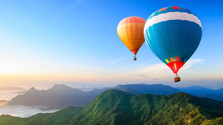 blue and white hot air balloon illustration, two blue and orange hot air balloons airborn over mountains