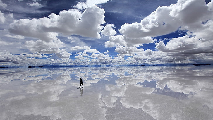 person walking on sea under blue and white sky, landscape, water