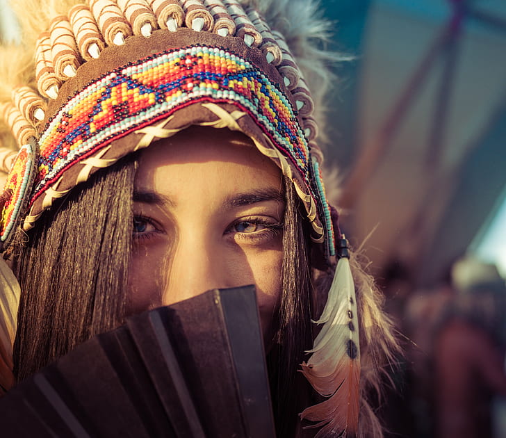 woman in multicolored native american hat during daytime, Burning Man