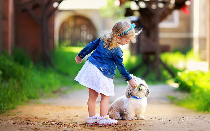 Cute little girl with dog, toddler's blue denim jacket