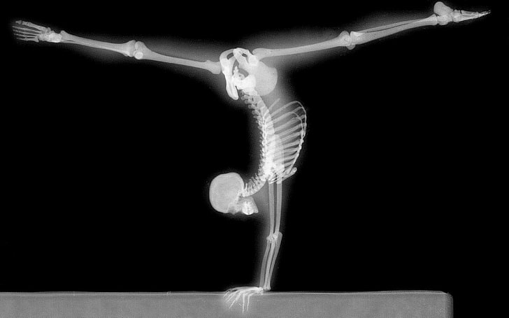 human skeleton, x-rays, gymnastics, bones, handstand, black background