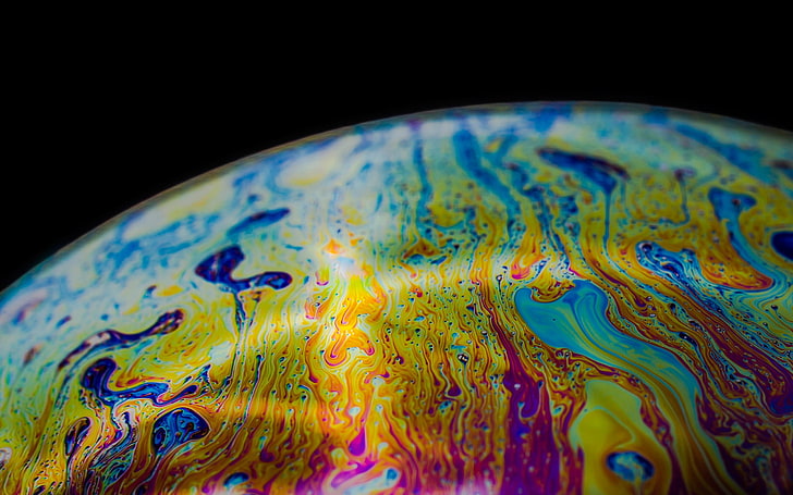 purple, pink, and white liquid, closeup photo of yellow, teal, and blue abstract artwork
