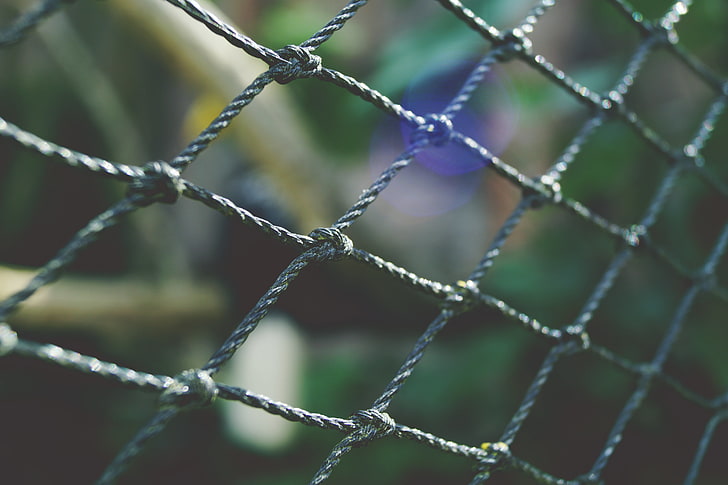 gray metal fence, mesh, weaving, grid, close-up, outdoors, netting