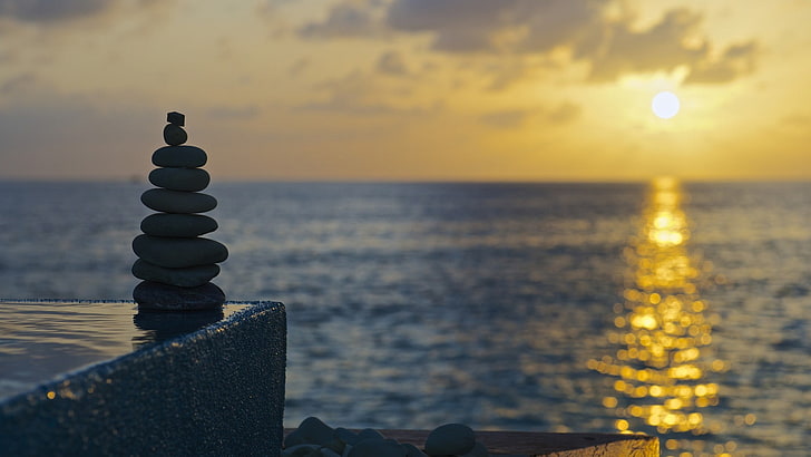 black and brown wooden table, sunset, sky, stones, sunlight, sea
