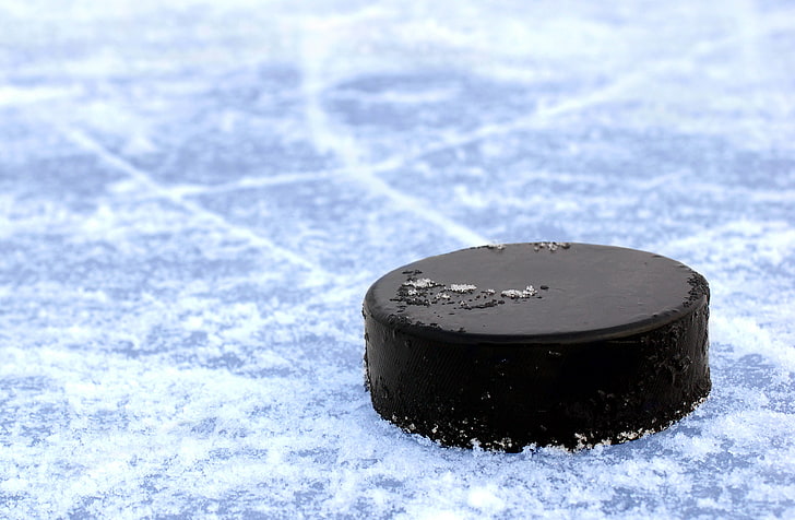 black hockey puck, ice, strip, blade, washer, macro., skates