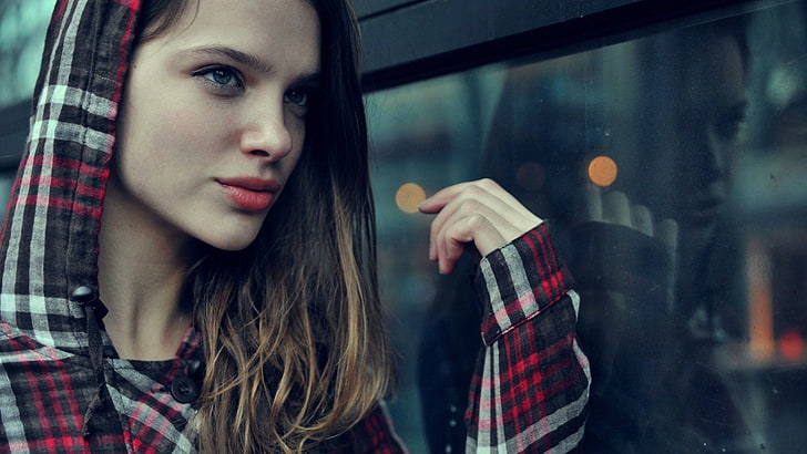 women's red, black, and white plaid hoodie, red lipstick, blue eyes