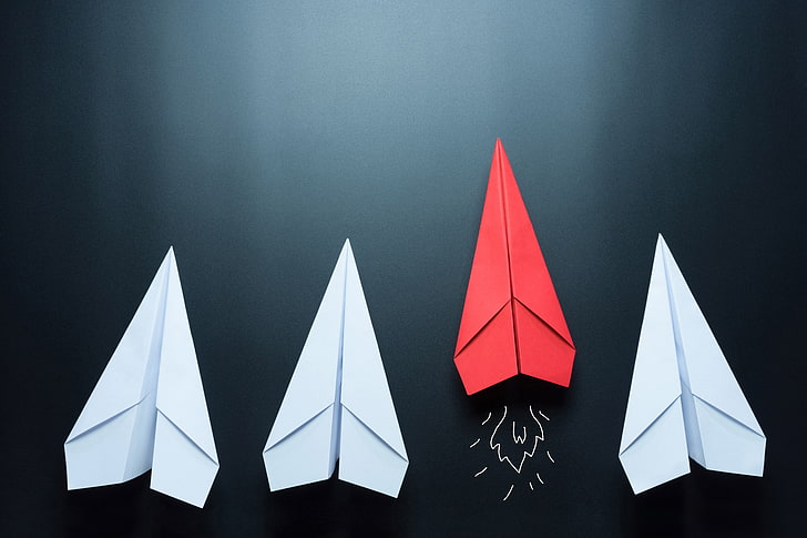three white and one red paperplanes, surface, wall, minimalism