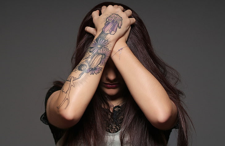 arms, tattoo, covering face, one person, indoors, young adult