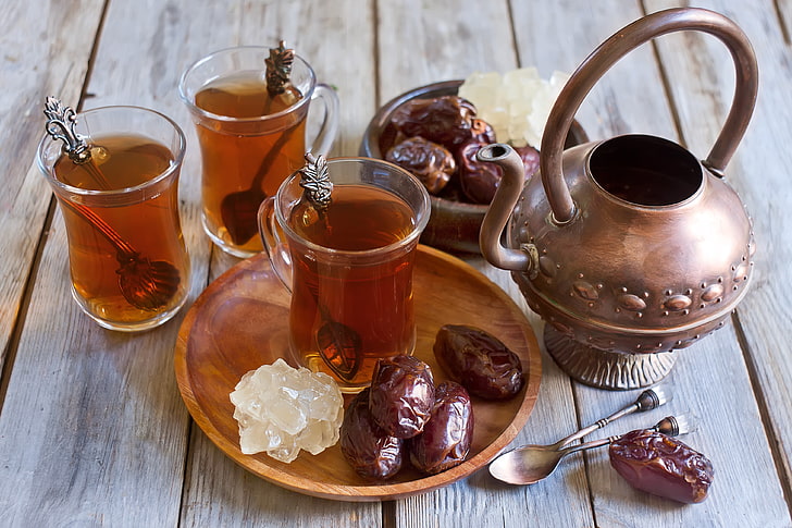 three clear Turkish tea cups, kettle, spoon, dates, spoons, Arabic tea