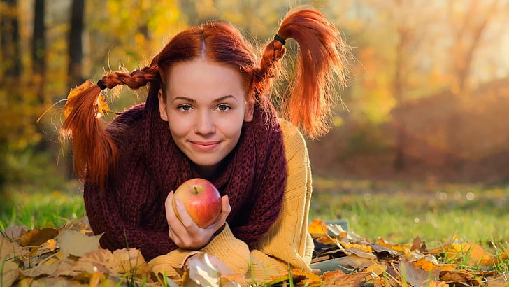 women's maroon scarf, selective focus photography of woman holding apple
