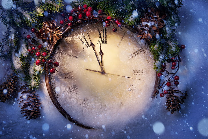 round beige analog clock with brown wooden frame, winter, snow