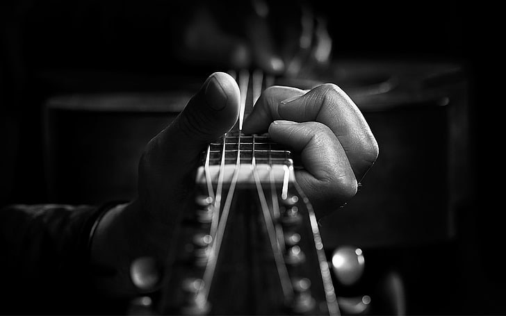 person playing guitar grayscale photo, monochrome, musical instrument