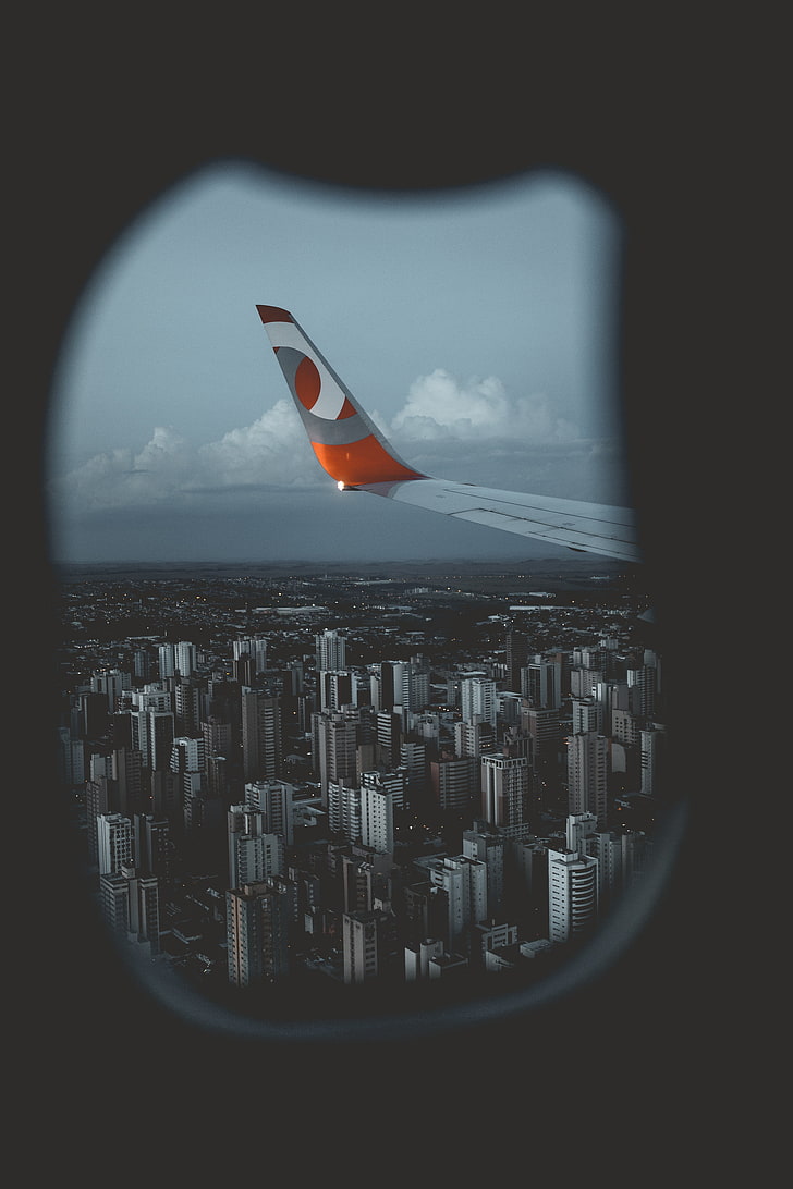 city landscape, wing aircraft, porthole, view from above, flight