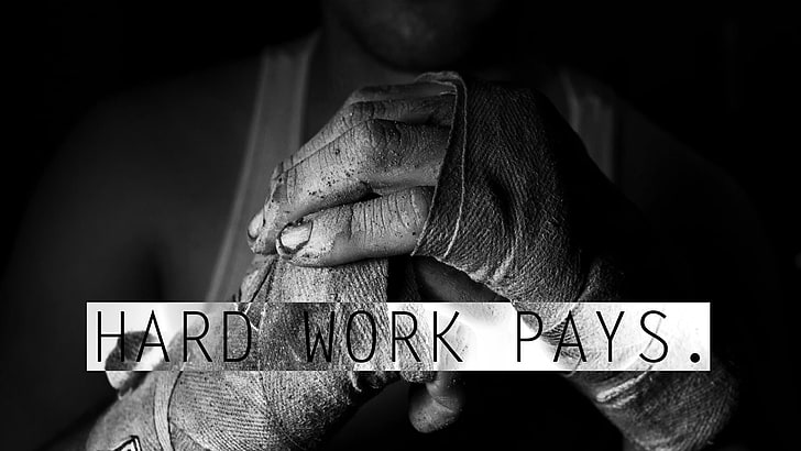 white tank top with text overlay, grayscale photo of man holding his fist with Hard Work Pays. text overlay