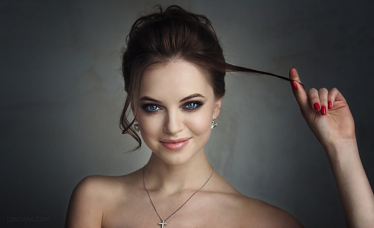 women's silver-colored necklace, brunette, blue eyes, smirk, smoky eyes