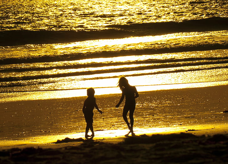 silhouette of two children playing near the seawave, Kids, Sunset