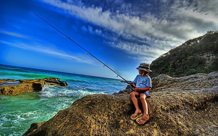 boy's blue crew-neck t-shirt and blue shorts, sea, shore, fishing