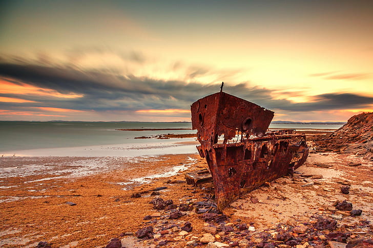 rusted boat washed out off shore near water, Wrecked, Explore