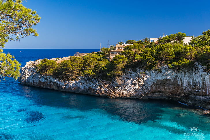 aerial view of house on top of a mountain that is covered with blue sea under the blue sky during daytime, mallorca, mallorca