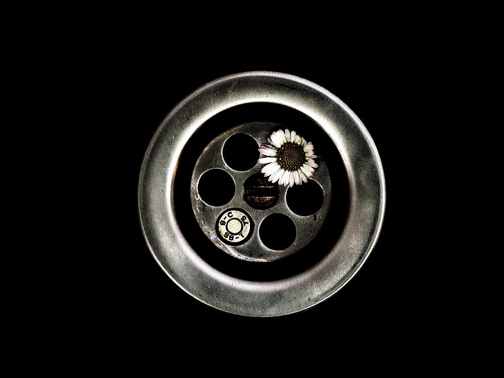 gray revolver magazine, black background, flowers, screw, circle