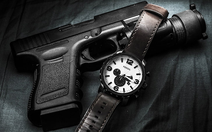 Glock German Gun And Watches, round black chronograph watch with brown leather strap and black semi-automatic pistol