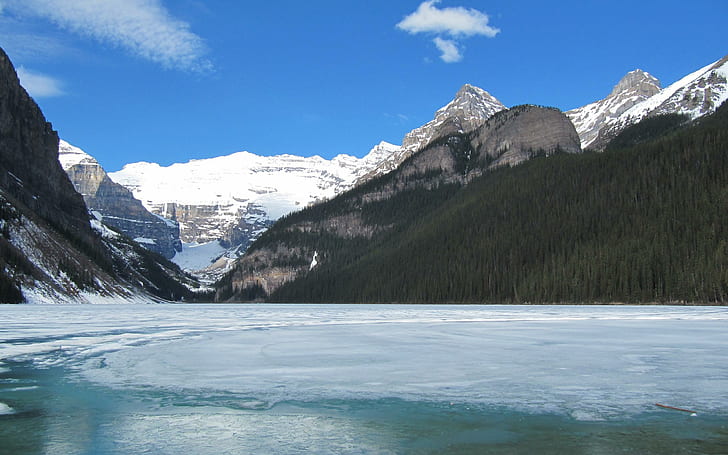 Lake Louise In May, rocky mountain coated with snow, frozen, mountains