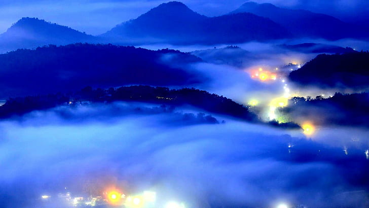 City Lights In Mist, silhouette of mountain covered by white clouds
