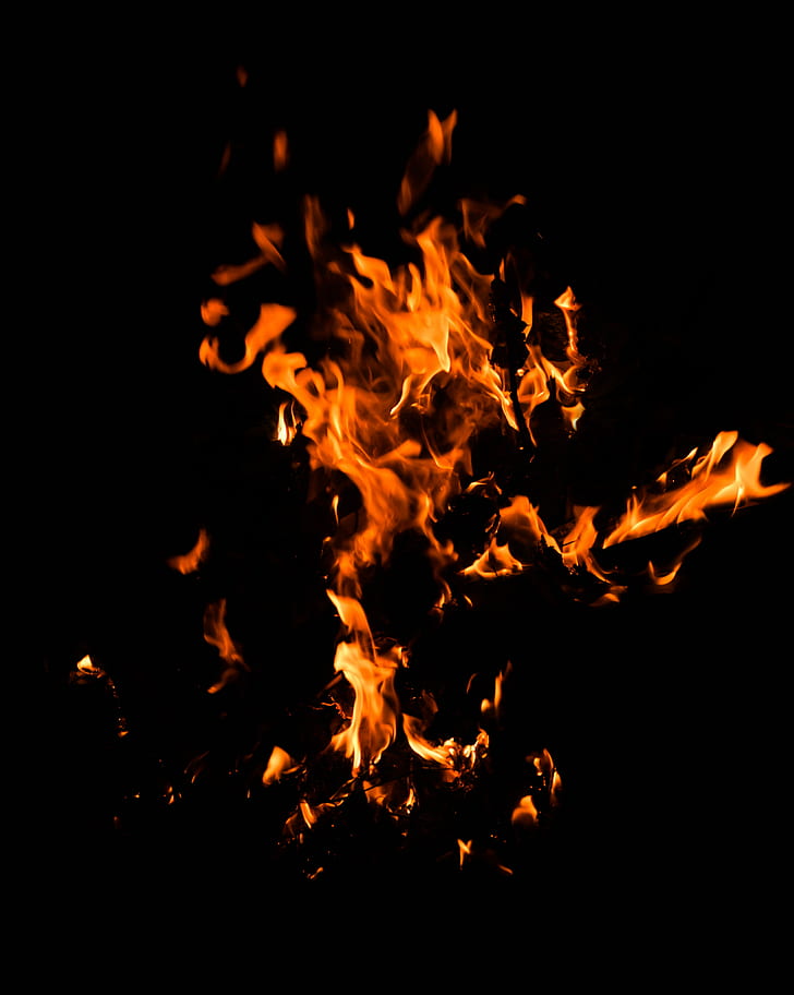 Premium Photo  Heart on fire isolated on black background