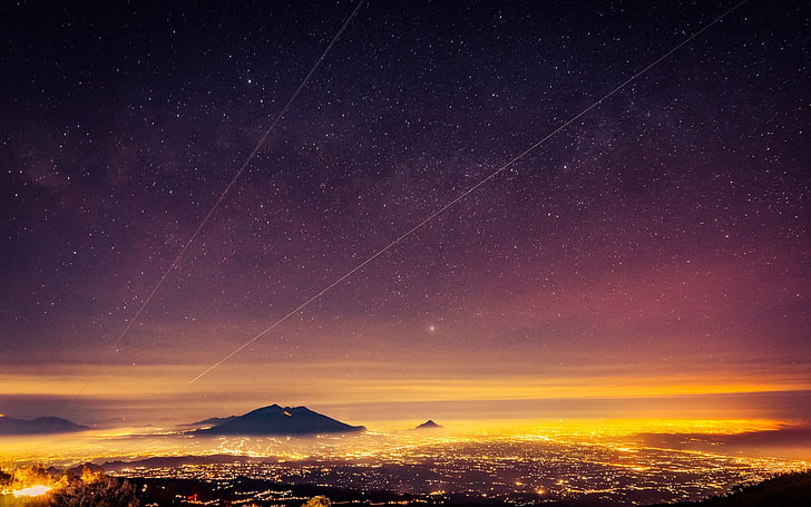 volcano under starry sky, aerial photo of city during golden hour