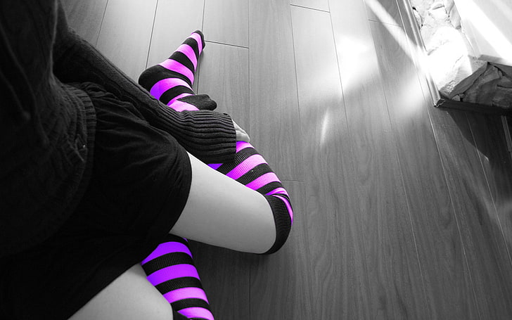 selective color photography of a person in pair of purple stripes high-socks