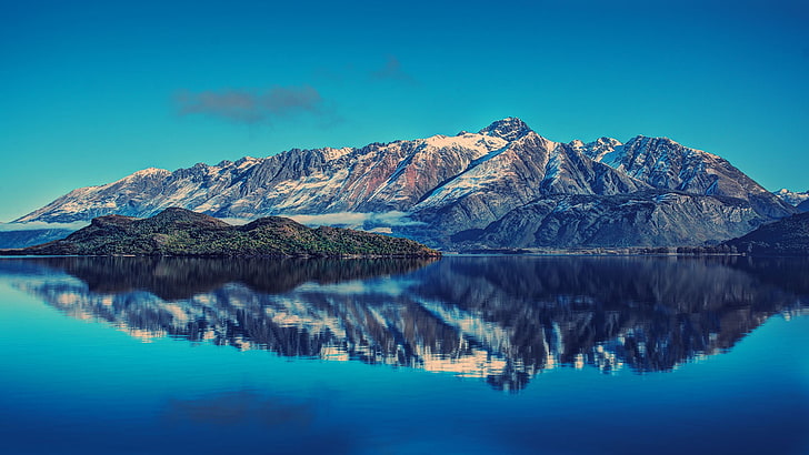 mountain ranges and body of water, selective focus photography of island