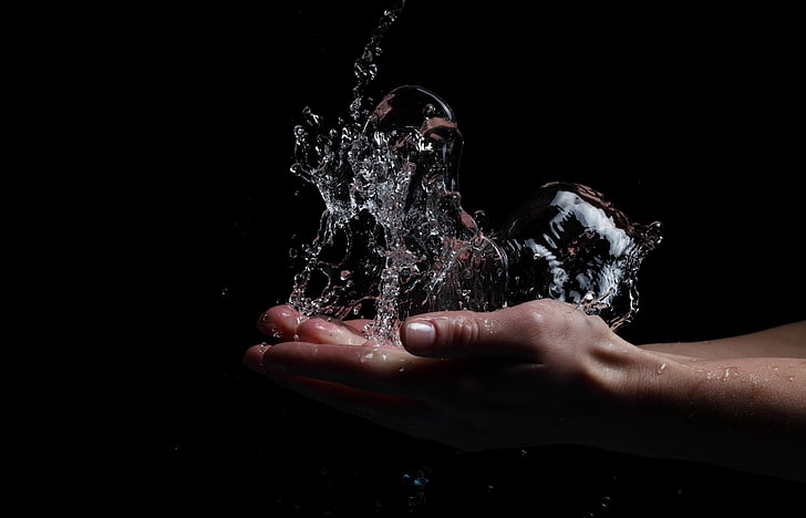 water, splashes, hands, black background, studio shot, human body part