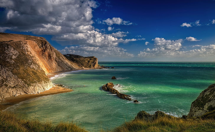 Blue Lagoon Durdle Door Dorset England, brown rock formation