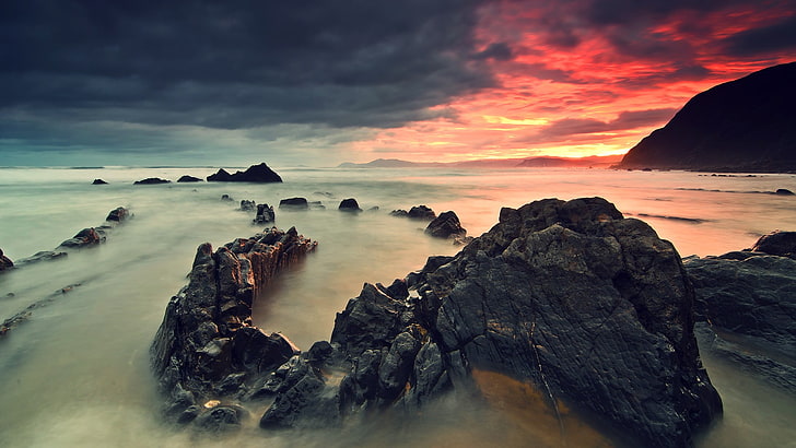 black rock formation, photo of a sunset, nature, mist, HDR, coast