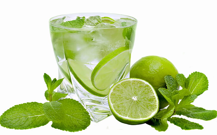 Summer cold drinks mojito, mint leaves, green lemon, clear drinking glass with lemon