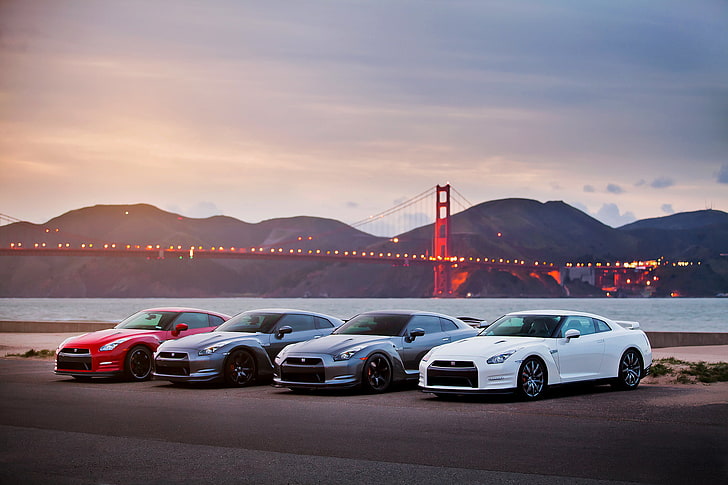 assorted-color Nissan GT-R coupes, sea, the sky, bridge, lights
