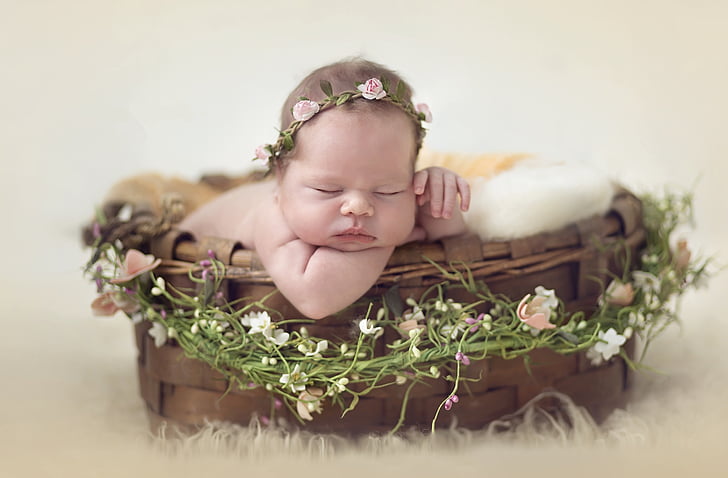baby with pink rose headdress sleeping on a basket, Cute baby