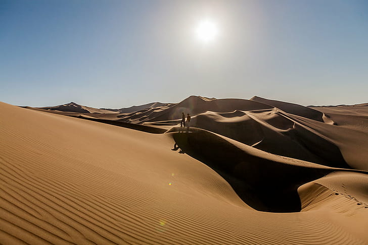 two people standing on desert field during daytime, peru, peru