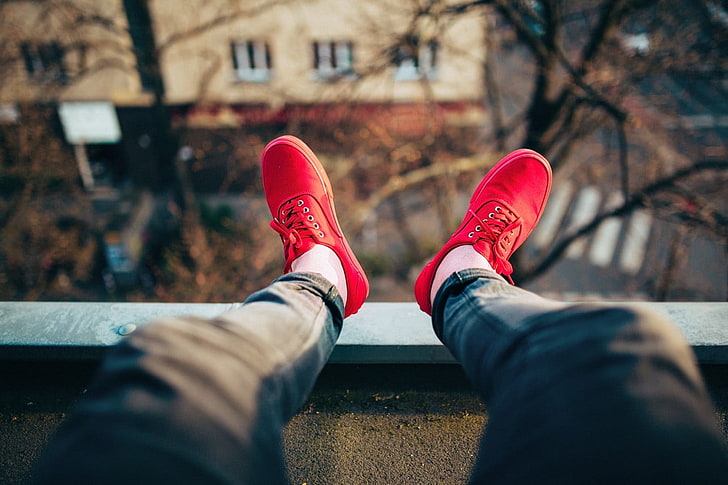 red lace-up low-top sneakers, red shoes, legs, depth of field