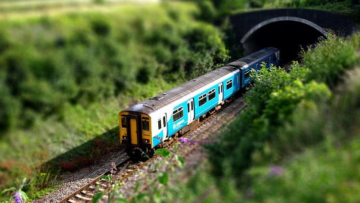 blue and white train, selective focus photography of miniature train