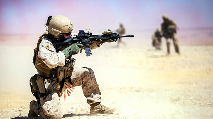Soldier holding black assault rifle crouching, M4, carbine, U.S. Army